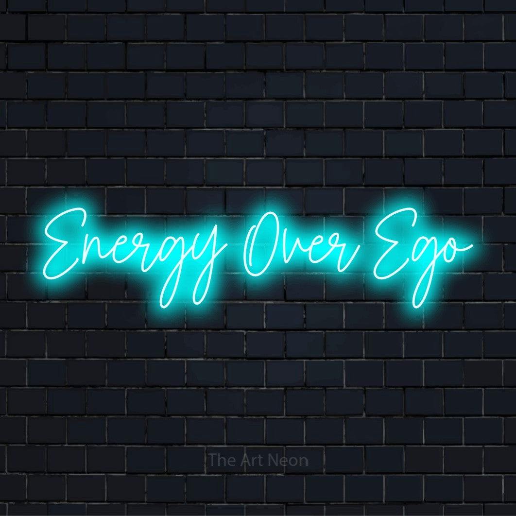 "Energy Over Ego" text design with neon effect on a black brick wall