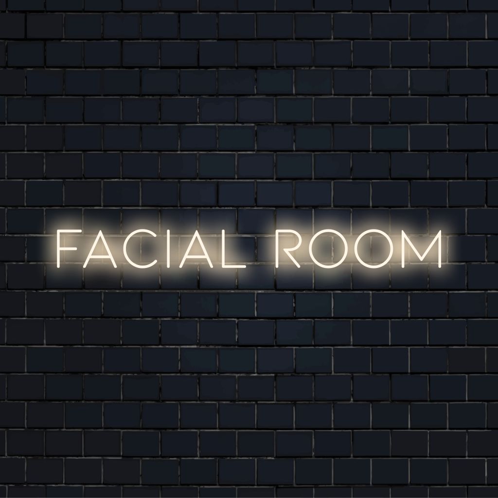 Facial Room LED Neon Sign, glowing neon text on black brick background