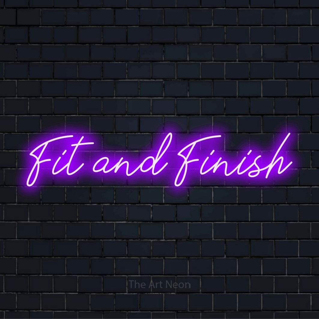 "Fit And Finish" text design with neon effect on a black brick wall