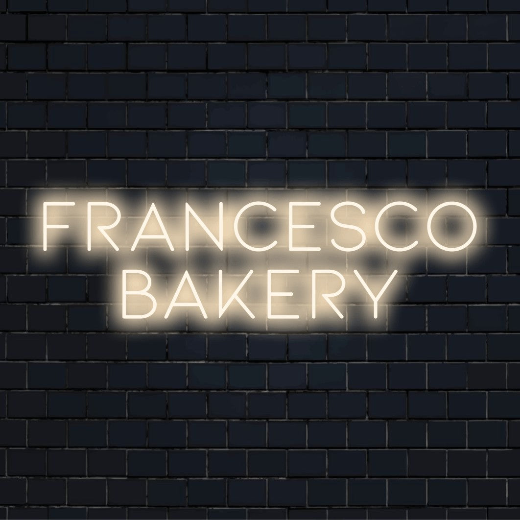Francesco Bakery Personalized Neon Light with bright LED glow against brick backdrop