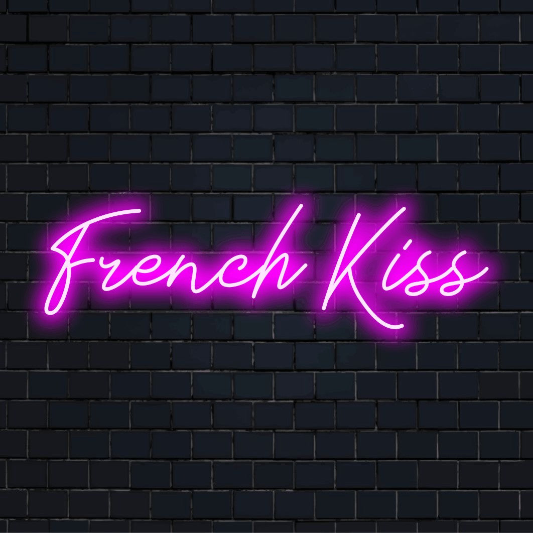 French Kiss Neon Light with bright LED glow on black brick background