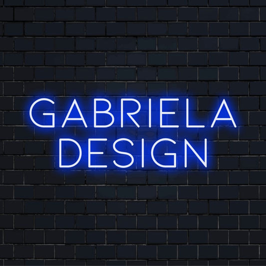 Gabriela Design Custom Name Neon Sign, glowing wall decor on black brick background
