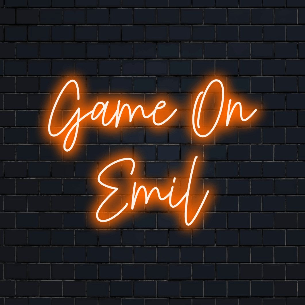 Game On Emil Personalized Neon Light with glowing lettering against black brick wall