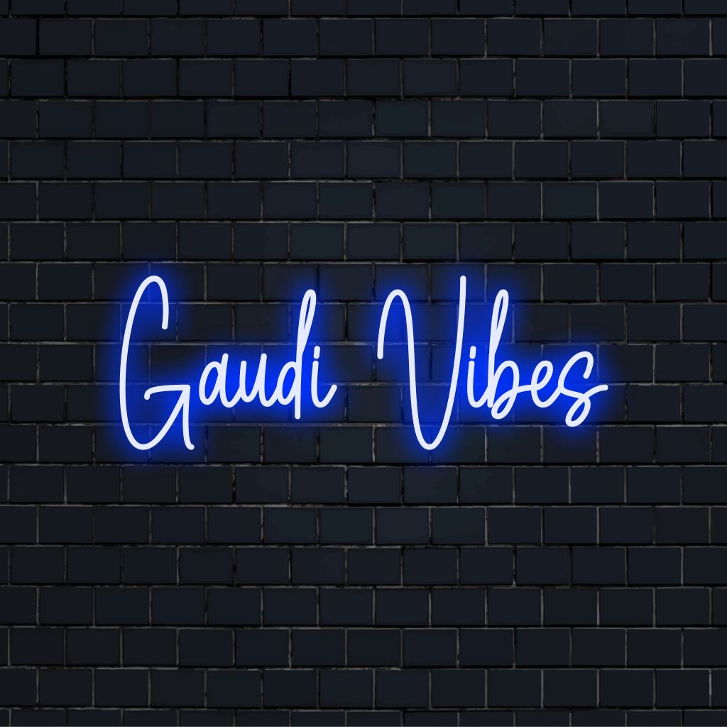 Gaudi Vibes Neon Light with neon text light against black brick wall