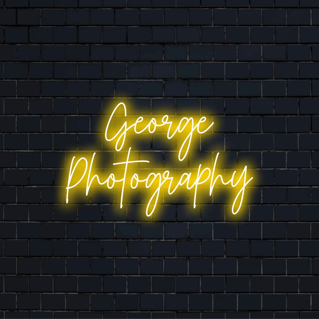 George Photography Personalized Neon Light with glowing lettering against black brick wall