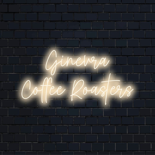 Ginevra Coffee Roasters Personalized LED Neon Sign, glowing wall decor against brick backdrop