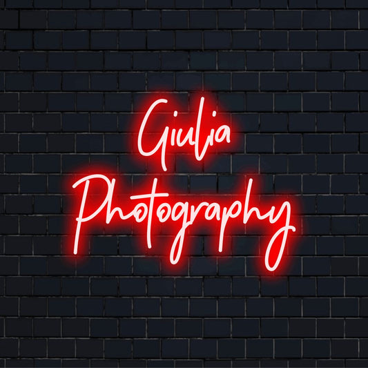 Giulia Photography Personalized Neon Light with bright neon lettering on black brick background