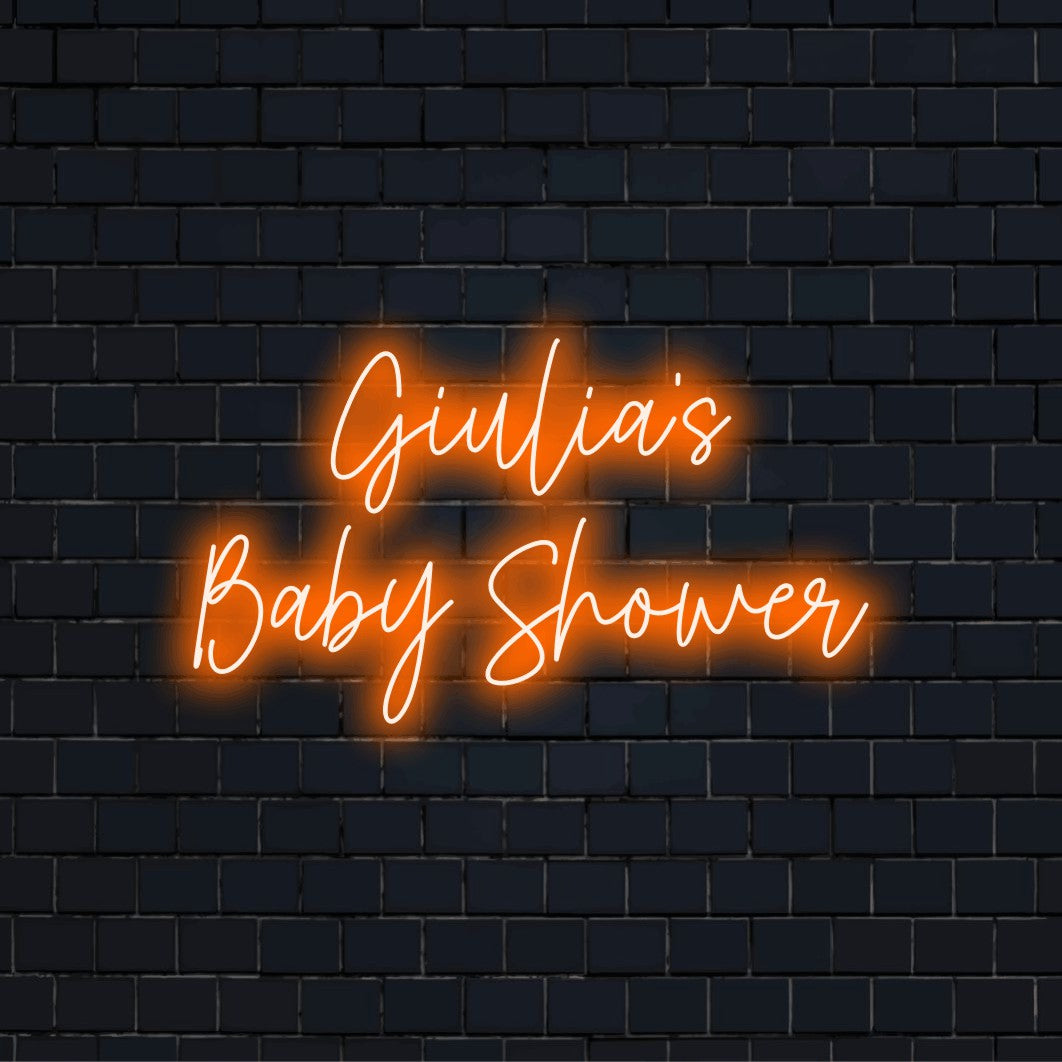 Giulia_s Baby Shower Custom Name Neon Sign, bright neon glow against brick backdrop