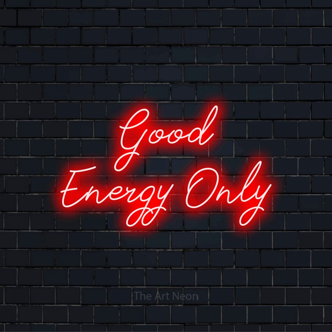 "Good Energy Only" glowing LED neon sign on a black brick wall