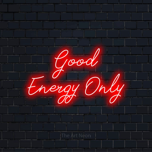 "Good Energy Only" glowing LED neon sign on a black brick wall