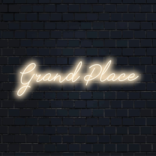 Grand Place LED Neon Sign, glowing lettering against black brick wall