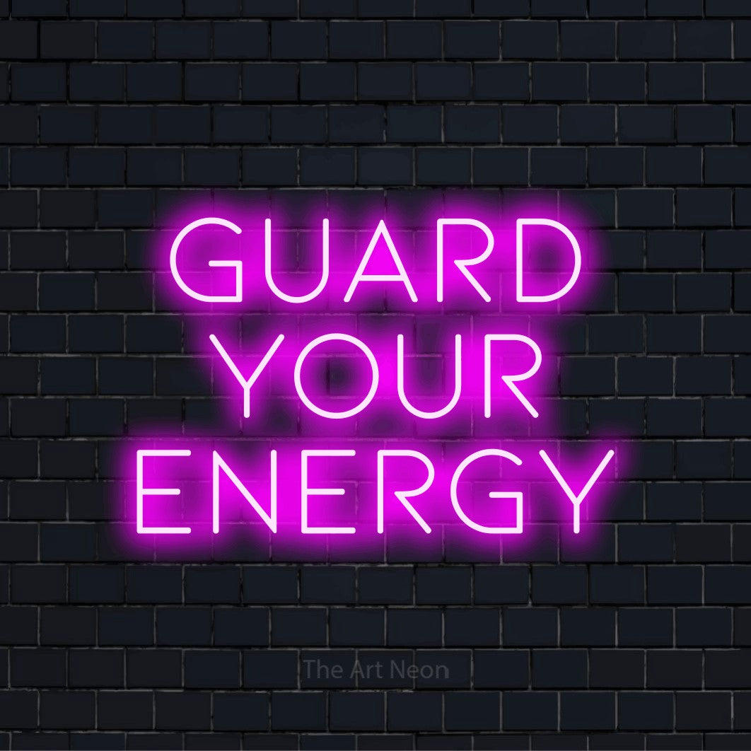"Guard Your Energy" neon text design on a black brick wall