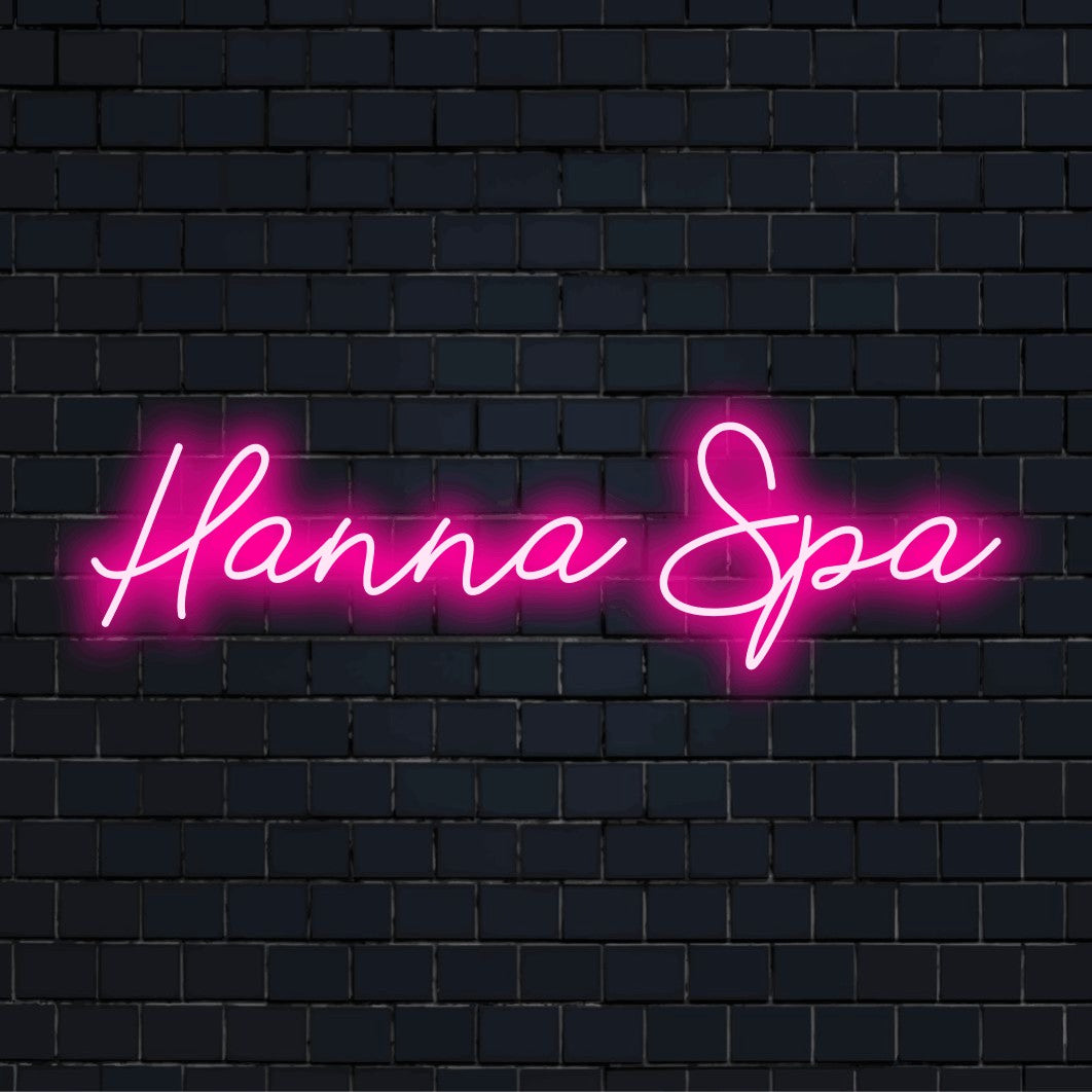 Hanna Spa Personalized Neon Light with bright neon lettering against black brick wall