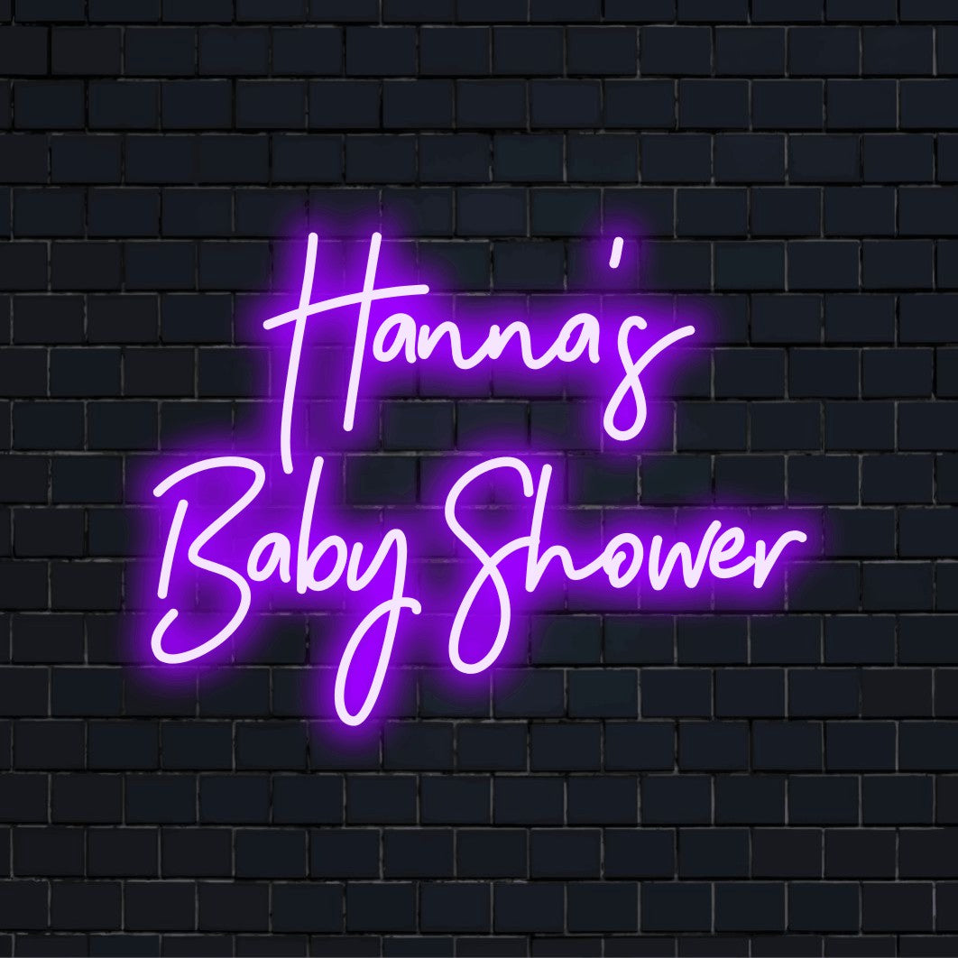 Hanna_s Baby Shower Personalized Neon Light with glowing lettering on dark brick background