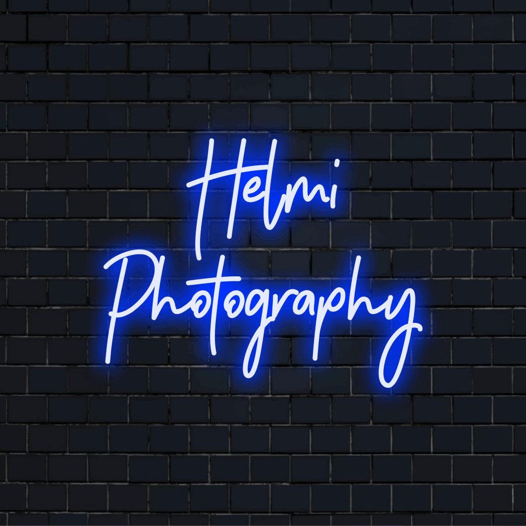 Helmi Photography Custom Name Neon Sign, soft neon glow on dark brick wall