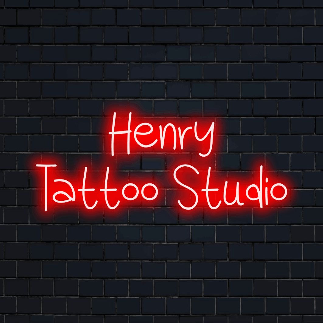 Henry Tattoo Studio Custom Name Neon Sign, neon text light on black brick background