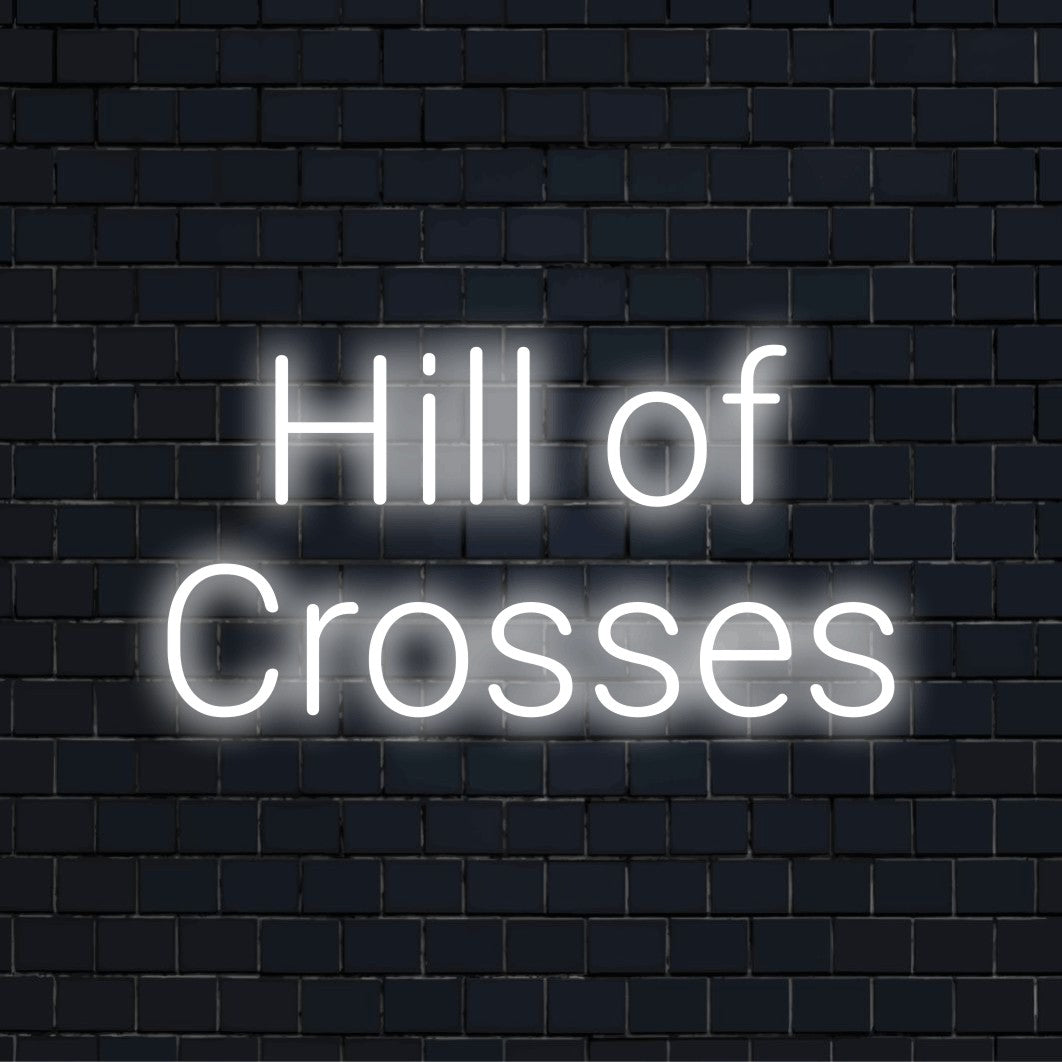 Hill Of Crosses Neon Sign, glowing wall decor against black brick wall