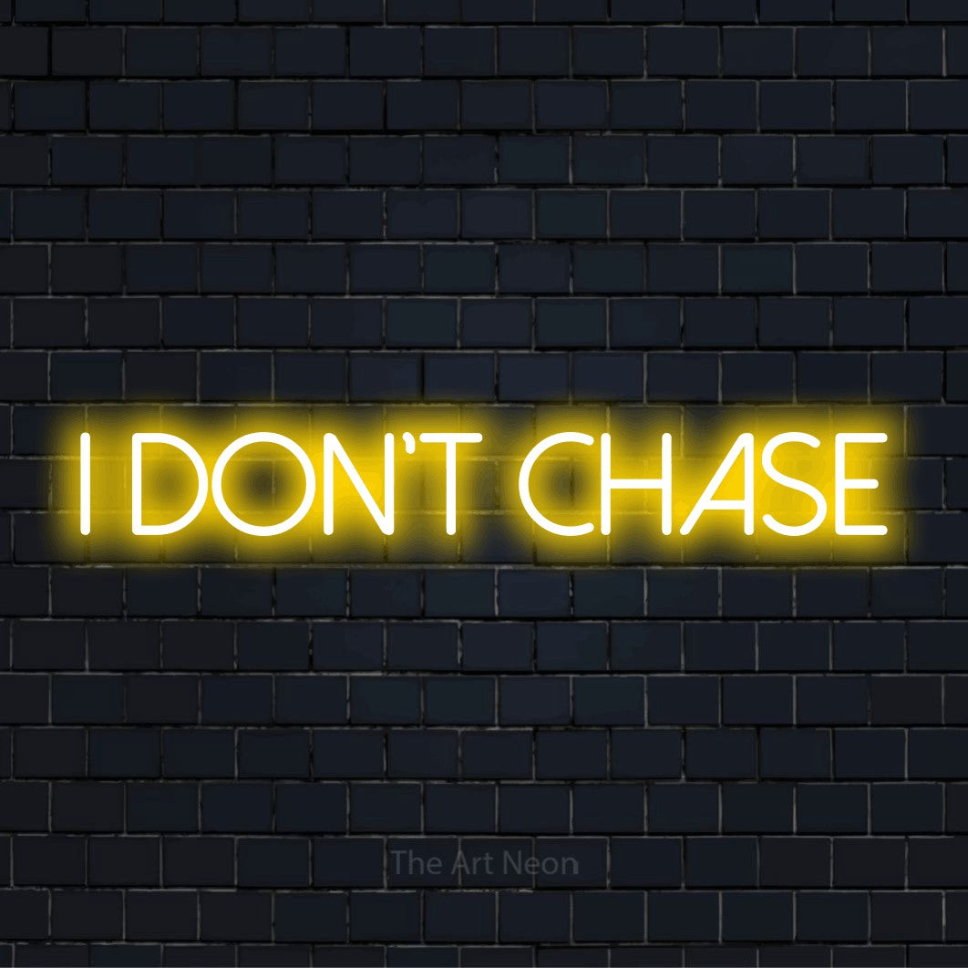 "I Don’t Chase" glowing LED neon sign on a black brick wall