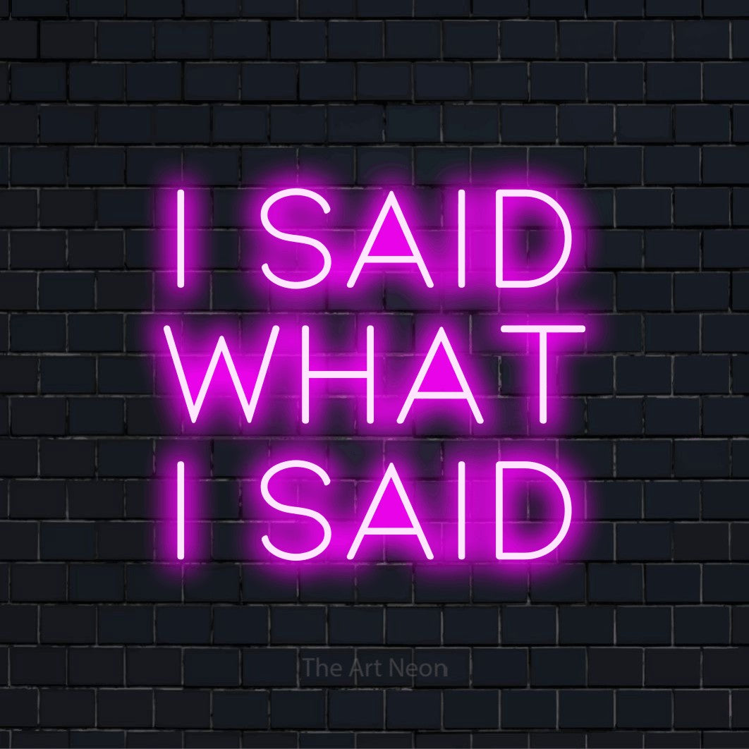 "I Said What I Said" neon text design on a black brick wall
