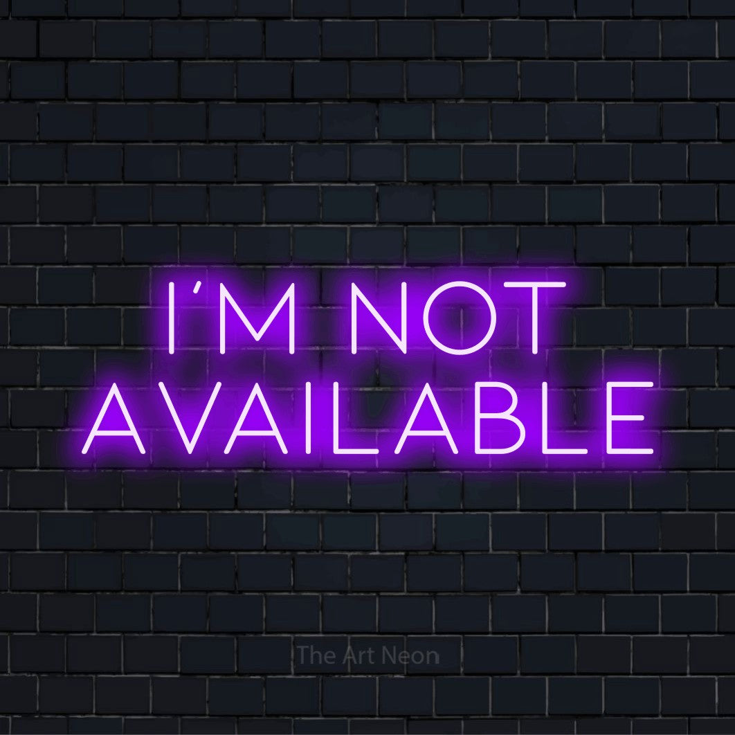 "I’m Not Available" script-style LED neon sign on a black brick wall