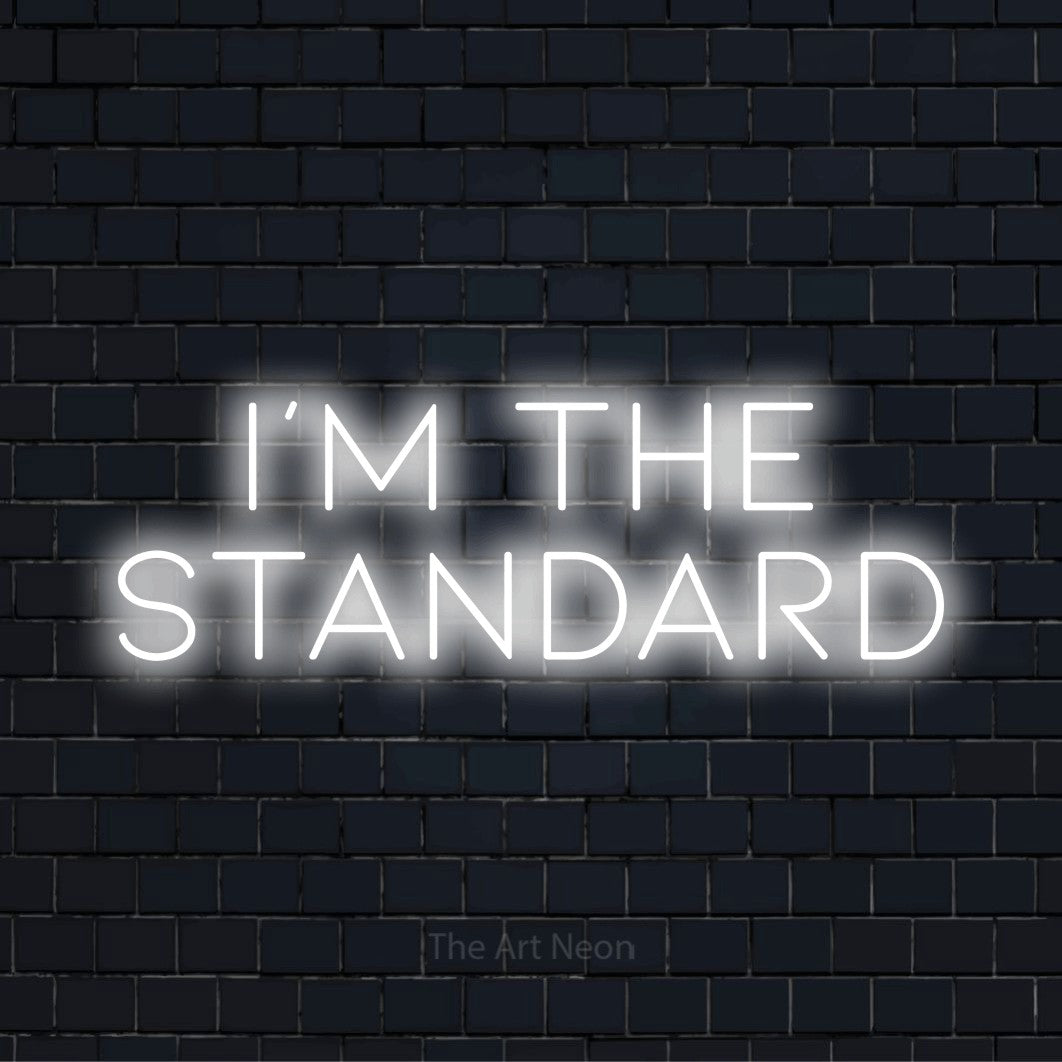 "I’m The Standard" neon text design on a black brick wall