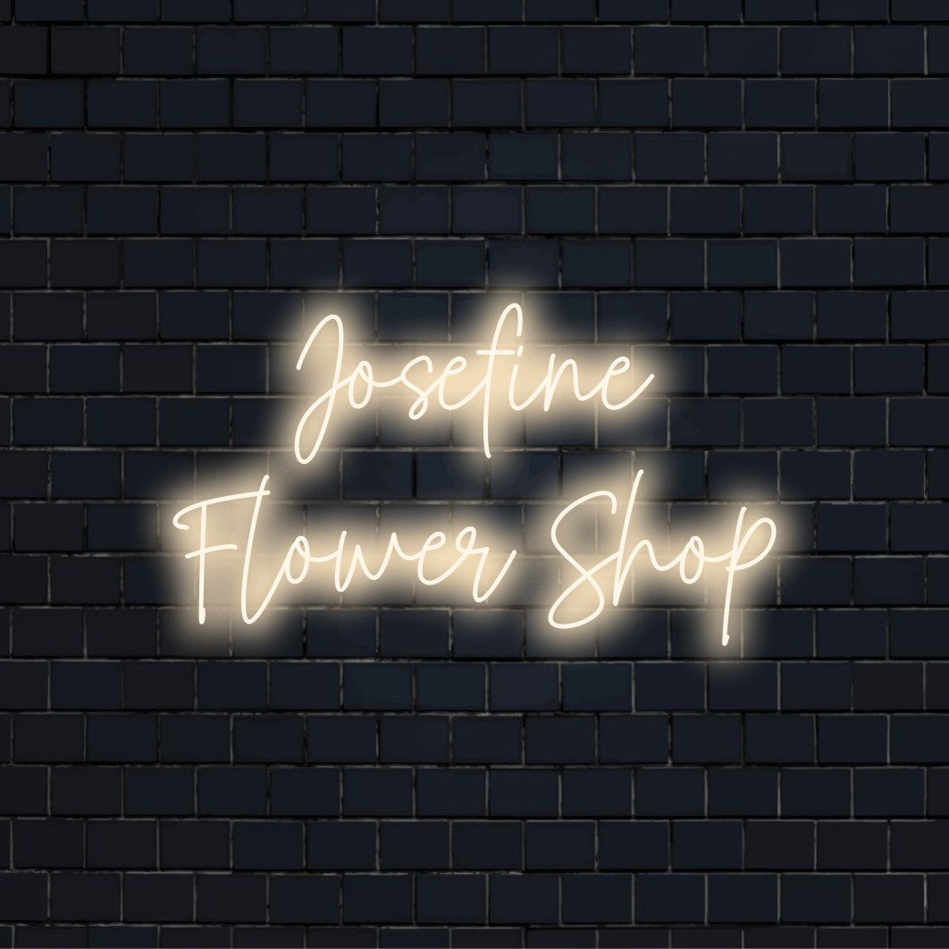 Josefine Flower Shop Personalized Neon Light with glowing lettering against brick backdrop