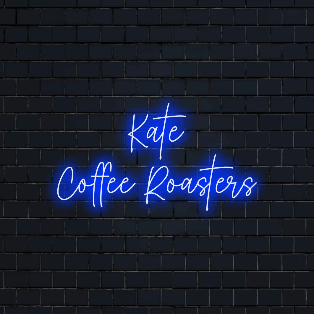 Kate Coffee Roasters Custom Name Neon Sign, glowing lettering on dark brick background
