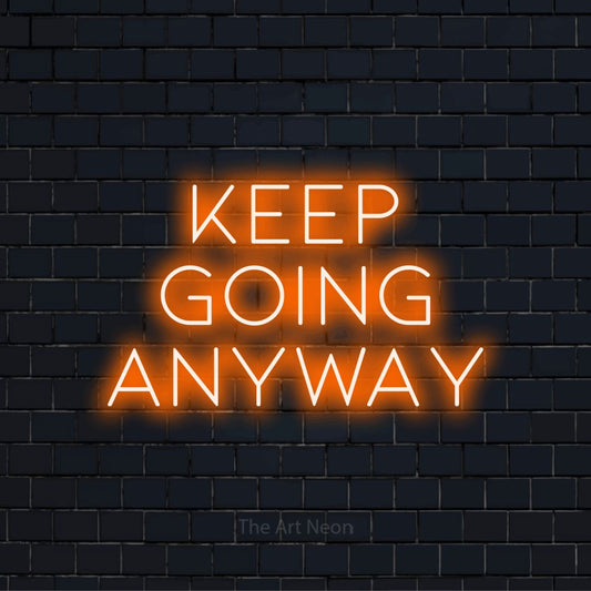 "Keep Going Anyway" neon text design on a black brick wall