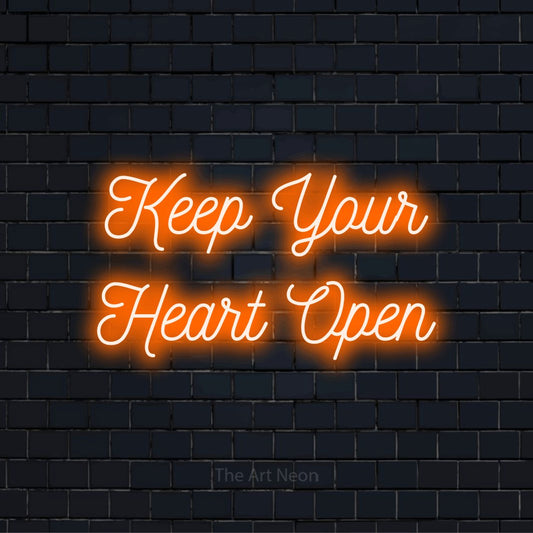 "Keep Your Heart Open" text design with neon effect on a black brick wall