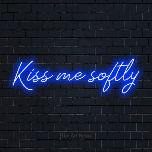 "Kiss Me Softly" glowing LED neon sign on a black brick wall