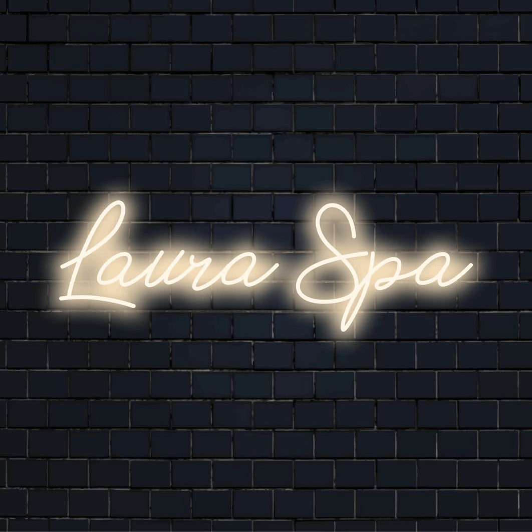 Laura Spa Custom Name Neon Sign, bright neon glow against black brick wall