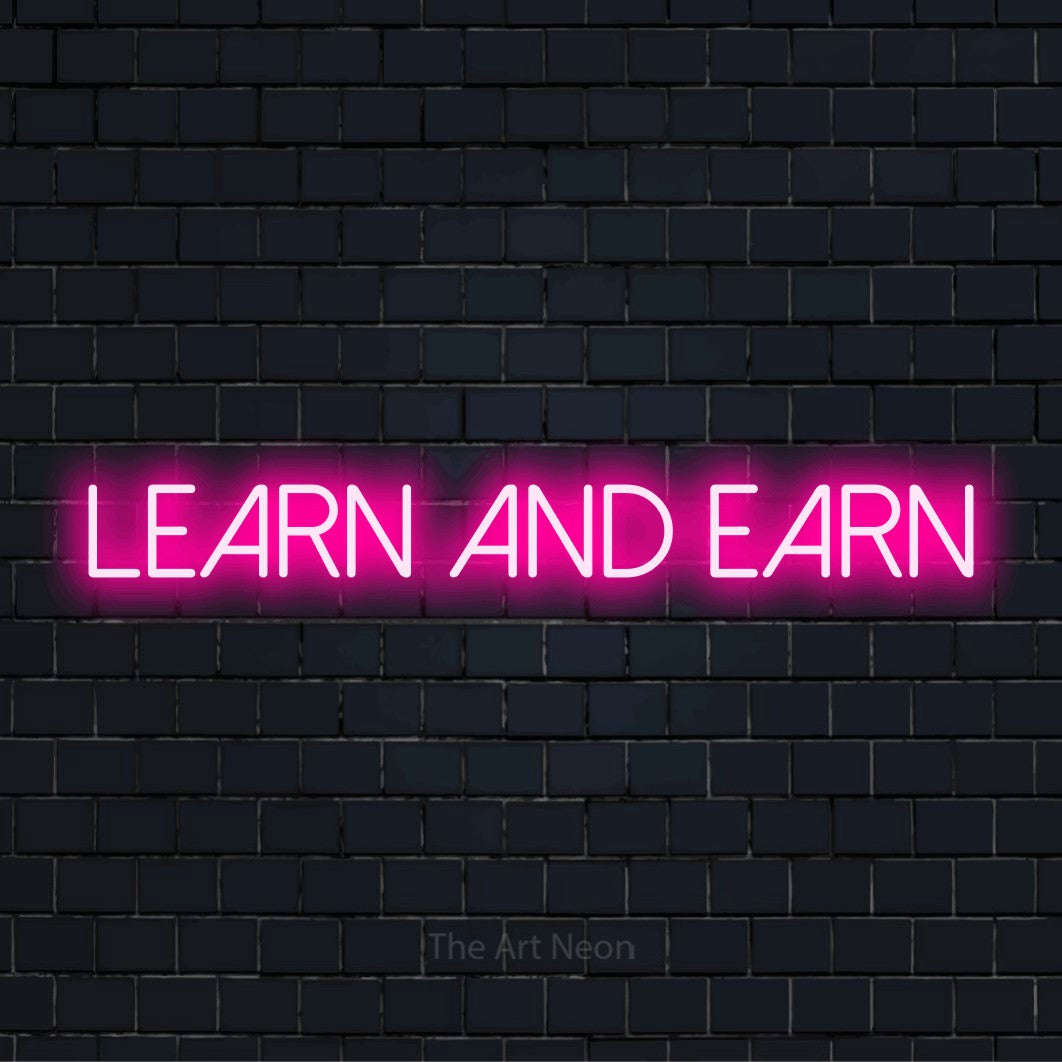 "Learn And Earn" script-style LED neon sign on a black brick wall