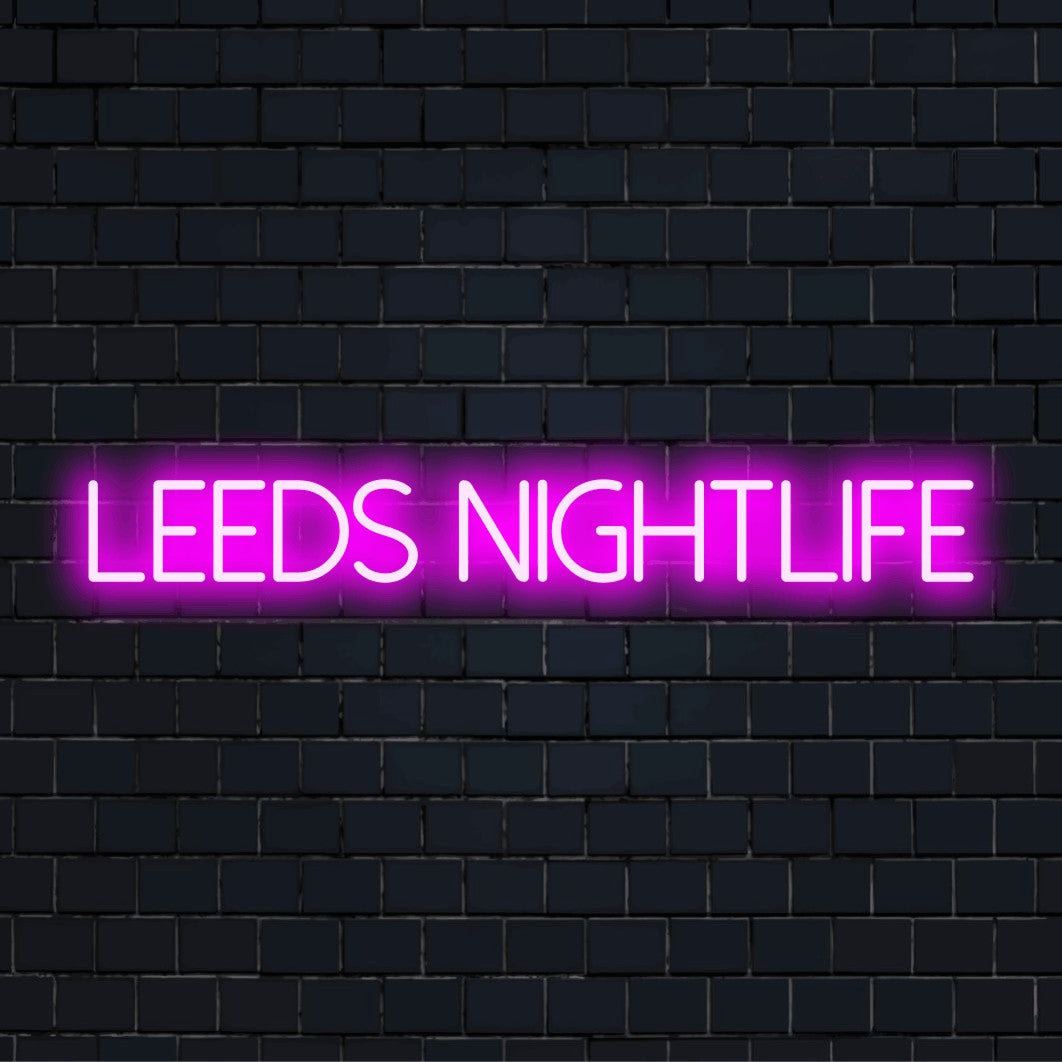 Leeds Nightlife LED Neon Sign, bright neon lettering on black brick background