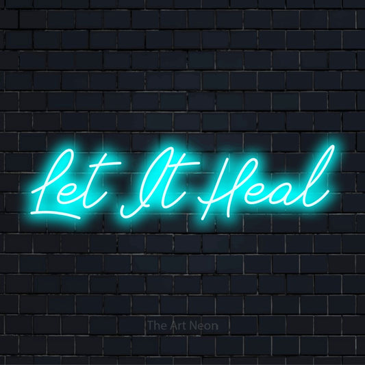 "Let It Heal" text design with neon effect on a black brick wall