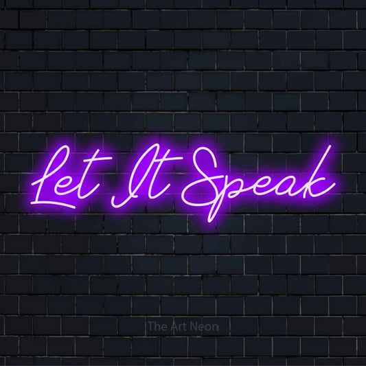 "Let It Speak" glowing LED neon sign on a black brick wall