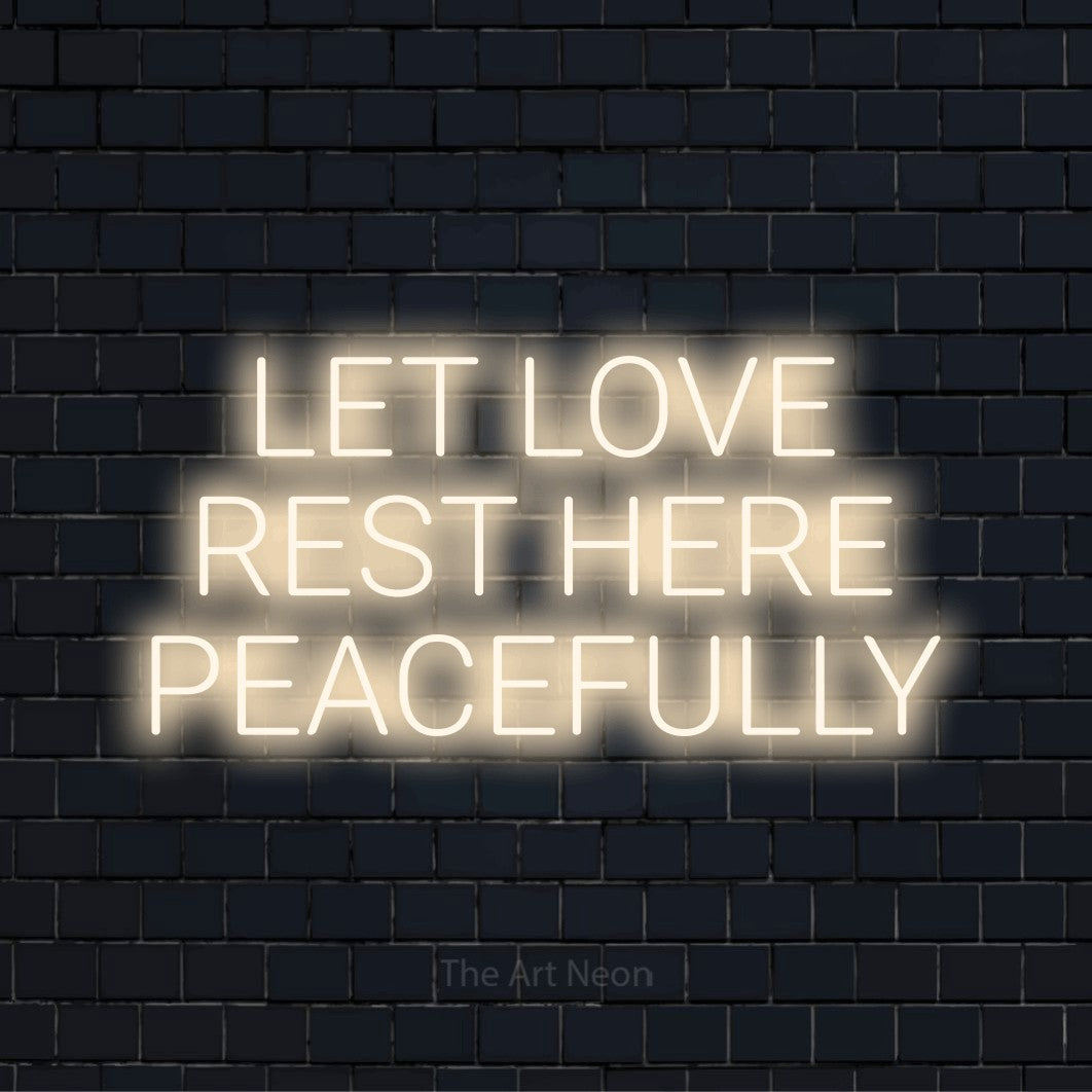 "Let Love Rest Here Peacefully" LED neon sign on a black brick wall