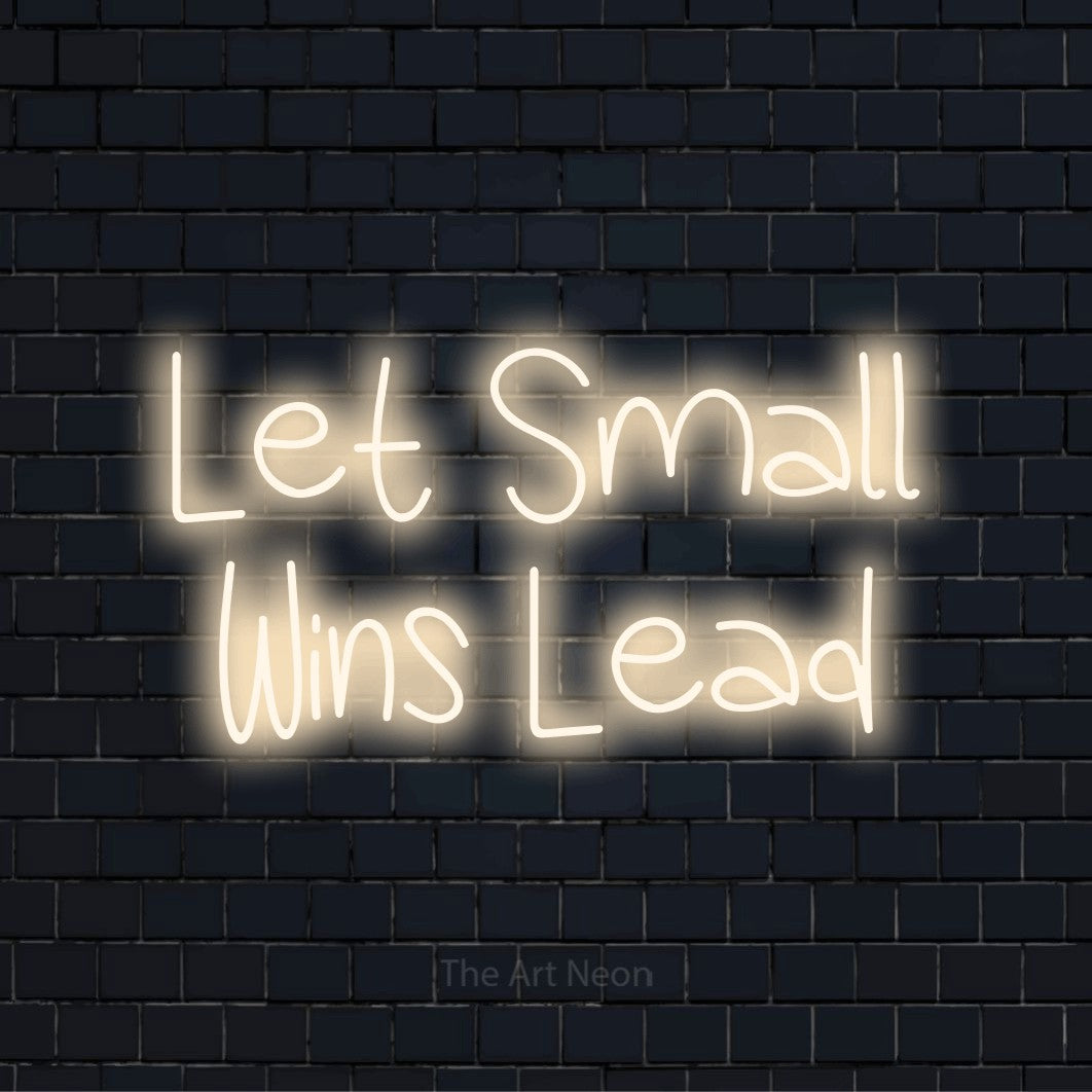 "Let Small Wins Lead" neon text design on a black brick wall