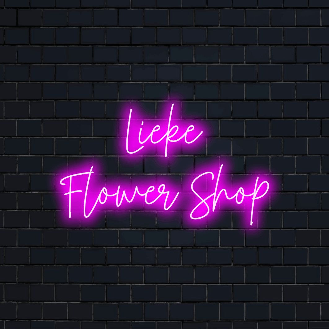 Lieke Flower Shop Personalized Neon Light with bright neon lettering on black brick background