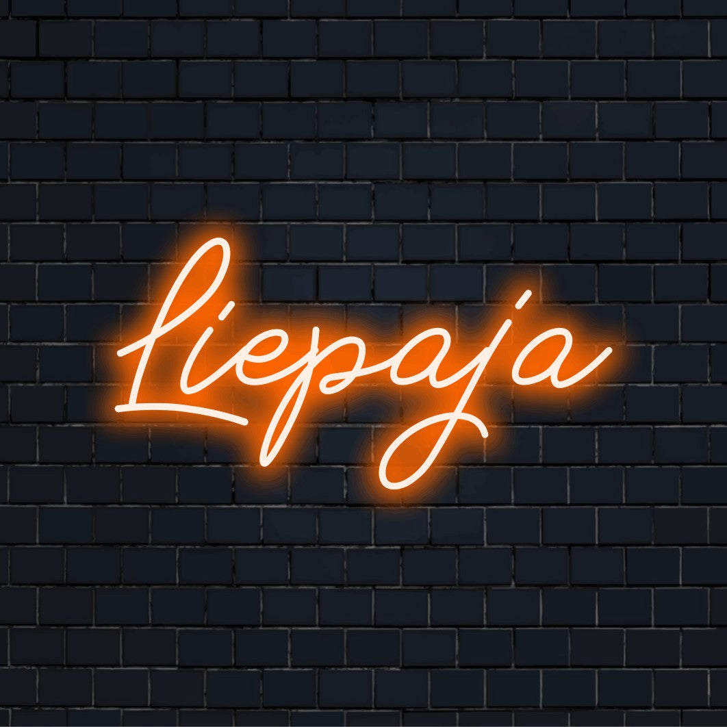 Liepaja LED Neon Sign, glowing lettering on black brick background