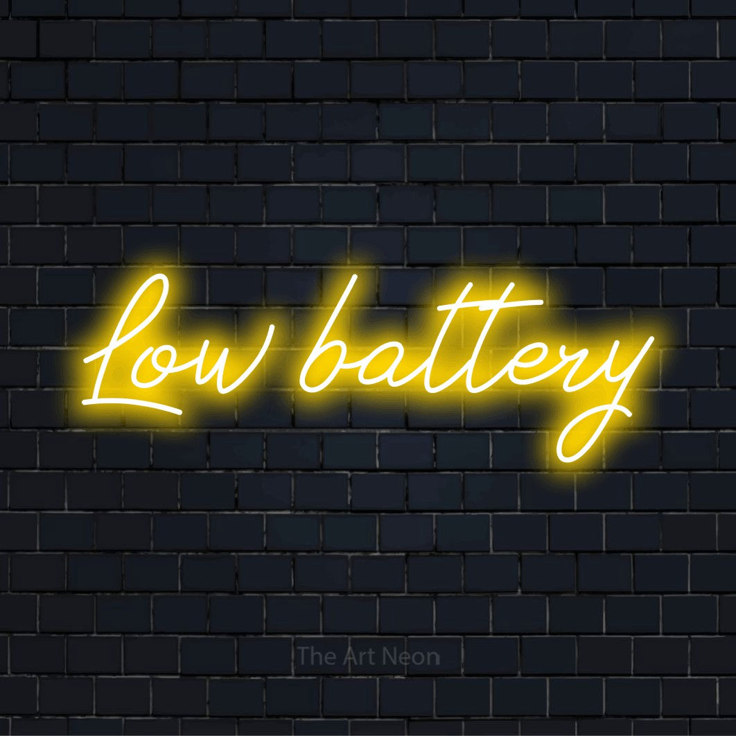 "Low Battery" neon text design on a black brick wall