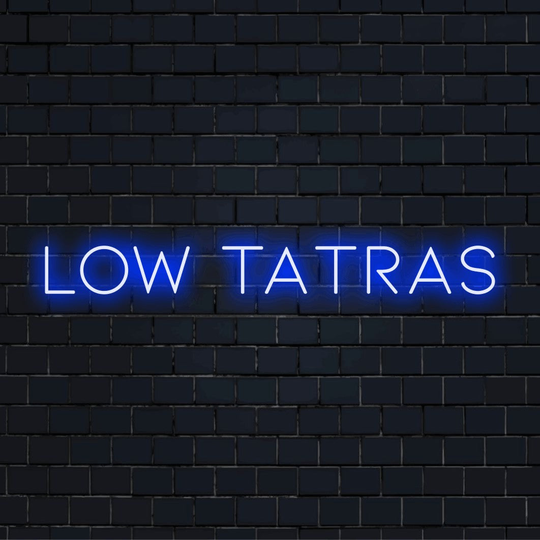 Low Tatras Neon Light with glowing wall decor against black brick wall