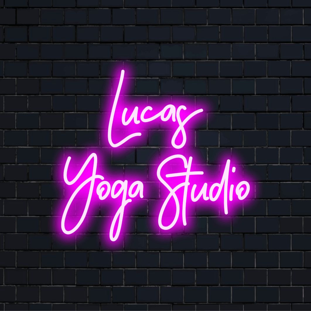 Lucas Yoga Studio Personalized LED Neon Sign, soft neon glow against black brick wall