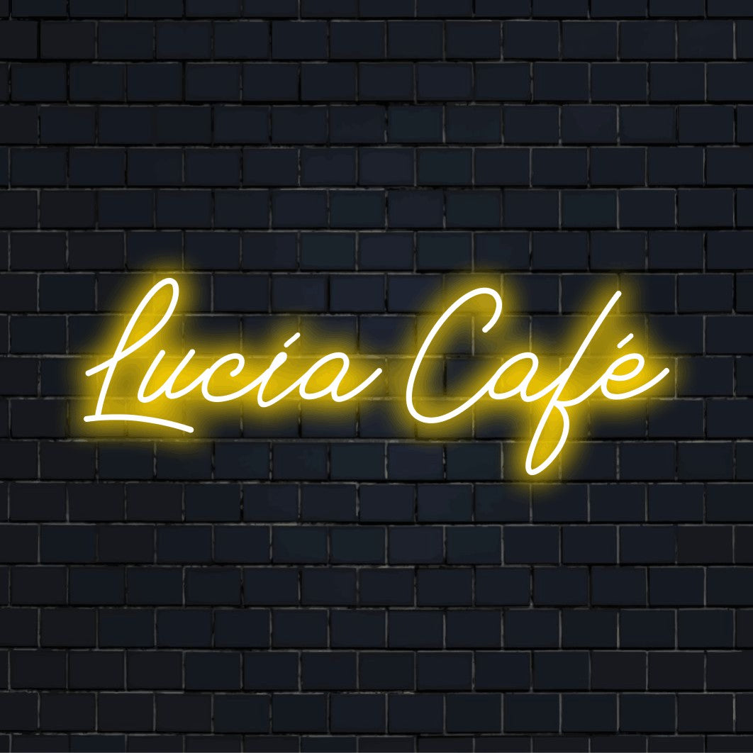 Lucia Cafe Custom Name Neon Sign, bright neon lettering on dark brick wall
