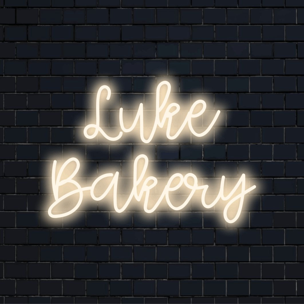 Luke Bakery Personalized LED Neon Sign, bright neon glow against brick backdrop