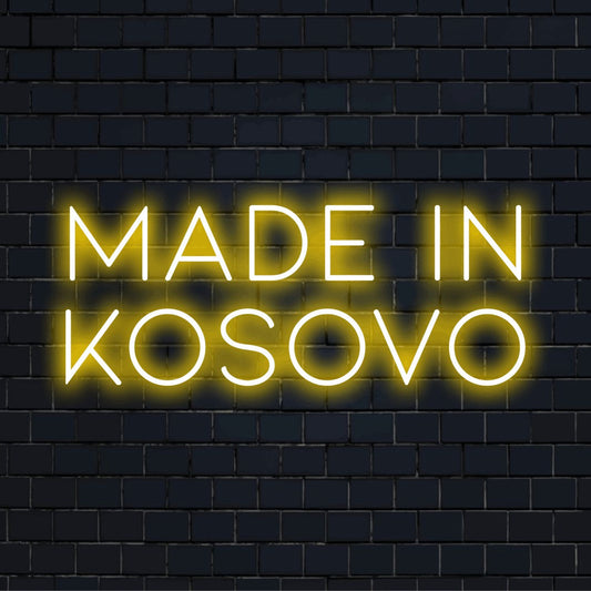 Made In Kosovo Neon Light with bright neon lettering against brick backdrop