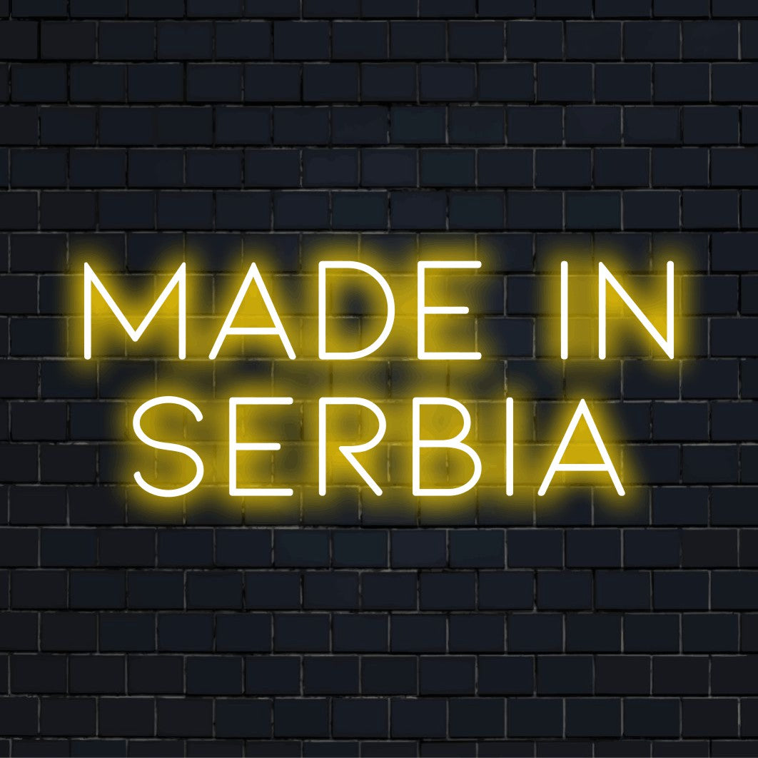 Made In Serbia Neon Light with bright neon lettering on dark brick background