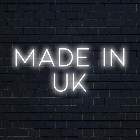 Made In Uk Neon Sign, neon text light against brick backdrop