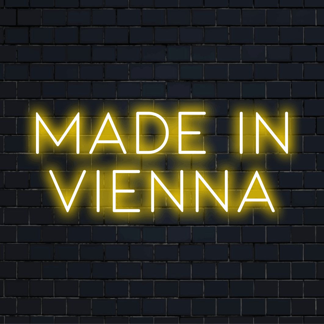 Made In Vienna LED Neon Sign, bright neon glow on dark brick wall