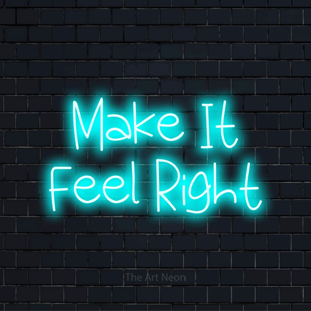 "Make It Feel Right" script-style LED neon sign on a black brick wall
