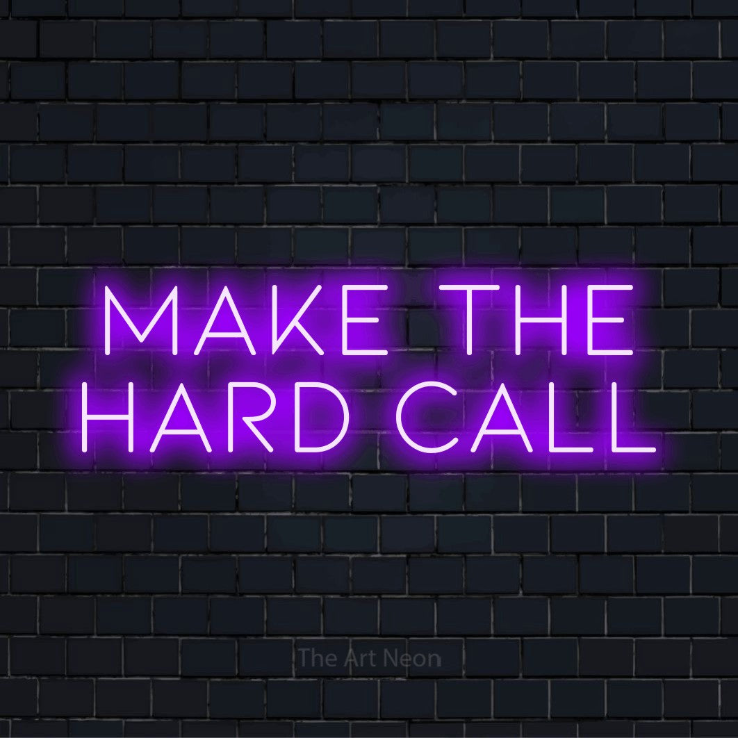 "Make The Hard Call" glowing LED neon sign on a black brick wall